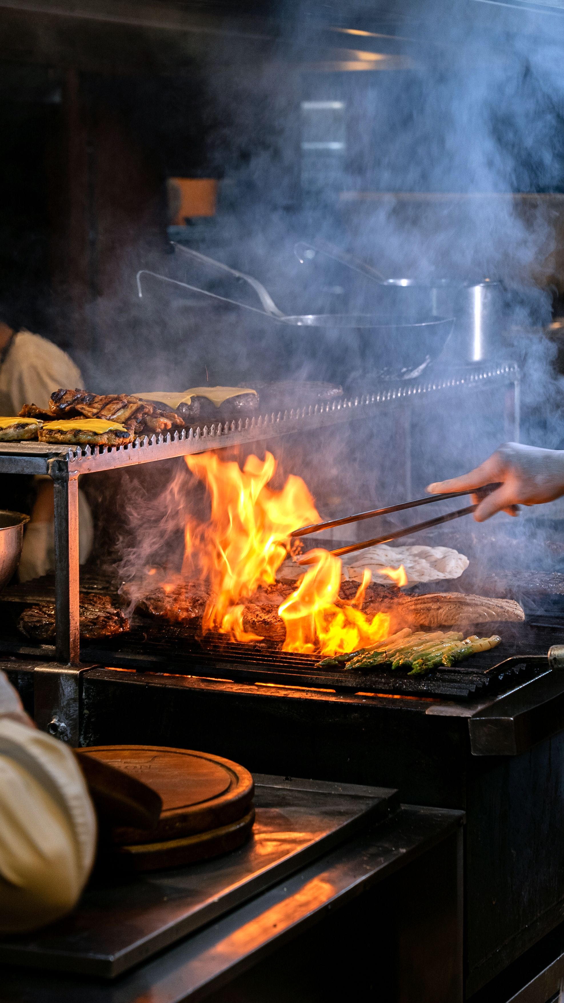 Live fire glowing under a barbecue grill